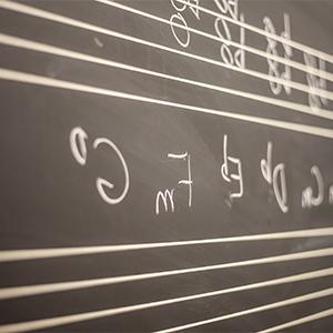 Music notation on a chalk board.